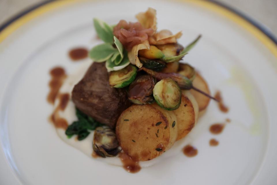 Calotte of Beef, Shallot Marmalade, Triple Cooked Butter Potatoes, Sunchoke and Creamed Watercress, and Red Wine Reduction is presented during a media preview ahead of the State Dinner in honor of French president Emmanuel Macron, in the State Dining Room of the White House in Washington, DC, on 30 November 2022 (AFP via Getty Images)