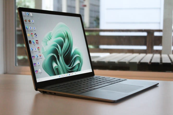 The Surface Laptop 5 on a table in front of a window.