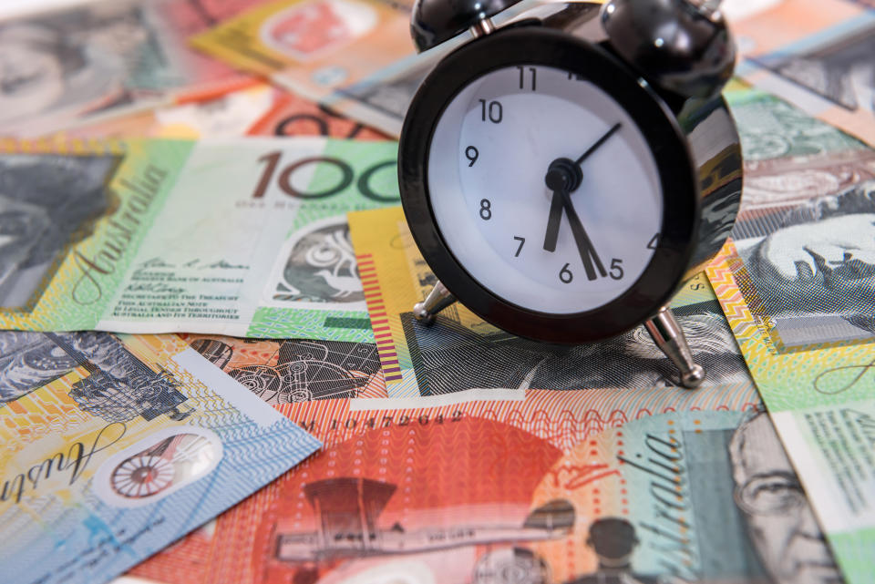 Clock with alarm at australian dollars close up