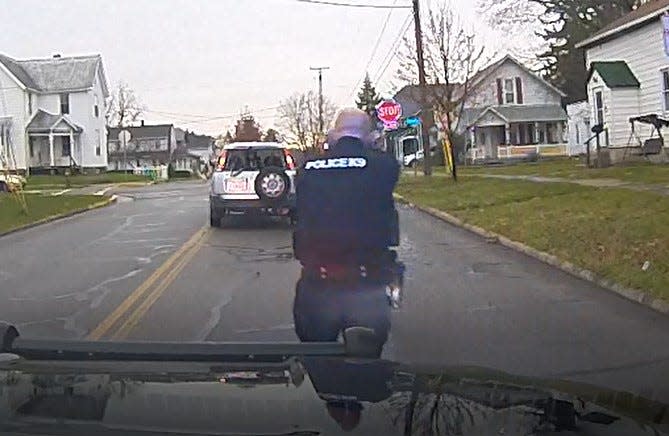 Bucyrus police Officer Devin Wireman approaches the suspect's vehicle, weapon raised, during a Nov. 11 shooting incident in this screen capture from a Bucyrus Police Department video.