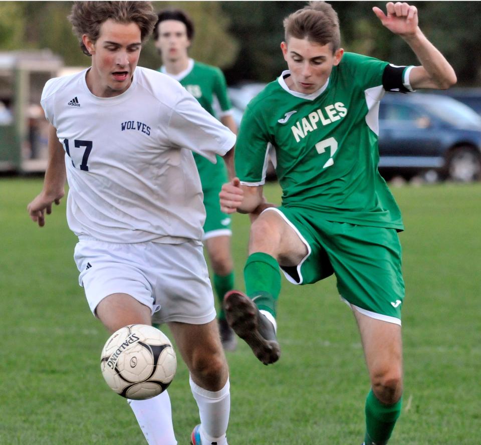 Rafael Ferguson (17) of HAC and Austin Chapman (7) of Naples battle for possession at midfield during Tuesday's match.