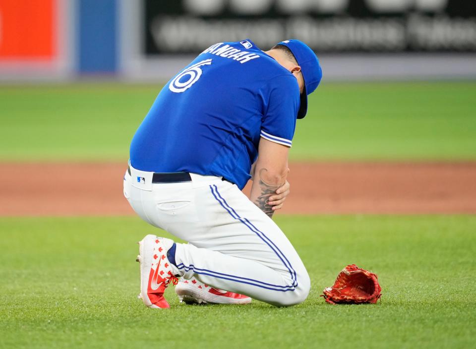 Alek Manoah of the Toronto Blue Jays holds his arm after being hit with a ball against the Detroit Tigers in the sixth inning at Rogers Centre in Toronto on Friday, July 29, 2022.