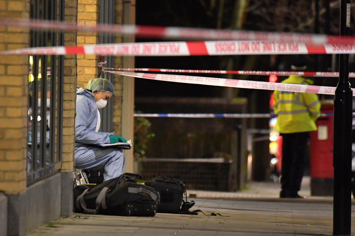 Forensic officers at the crime scene after Metropolitan police cordon off Charteris Road close to the junction with Lennox Road in Finsbury Park after a man was stabbed to death in north London on Friday evening.