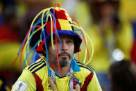 <p>Colombia fan looks dejected after losing the penalty shootout. REUTERS/Carl Recine </p>