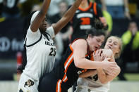 Oregon State forward Raegan Beers, center, fights for control of the ball with Colorado guard Maddie Nolan, right, as Colorado forward Brianna McLeod, left, defends in the second half of an NCAA college basketball game Sunday, Feb. 11, 2024, in Boulder, Colo. (AP Photo/David Zalubowski)