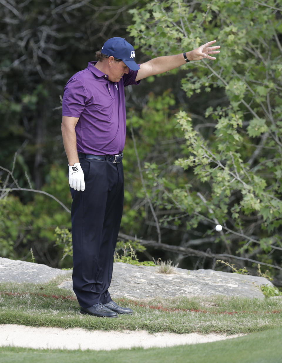 Phil Mickelson takes a drop from a hazard on the second hole during round-robin play against Si Woo Kim, of South Korea, at the Dell Technologies Match Play golf tournament at Austin County Club, Wednesday, March 22, 2017, in Austin, Texas. (AP Photo/Eric Gay)