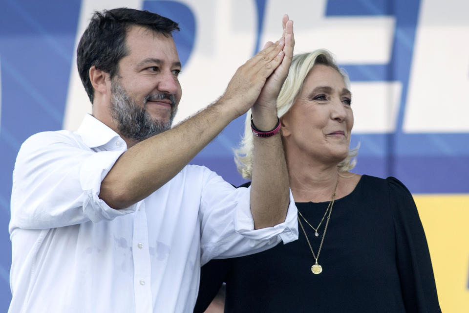 Italian Vice Premier Matteo Salvini, head of the populist, right-wing League, left, stands on stage with French right-wing leader Marine Le Pen on the occasion of an annual League (Lega) party rally, in Pontida, northern Italy, Sunday, Sept. 17, 2023. (Claudio Furlan/LaPresse via AP)