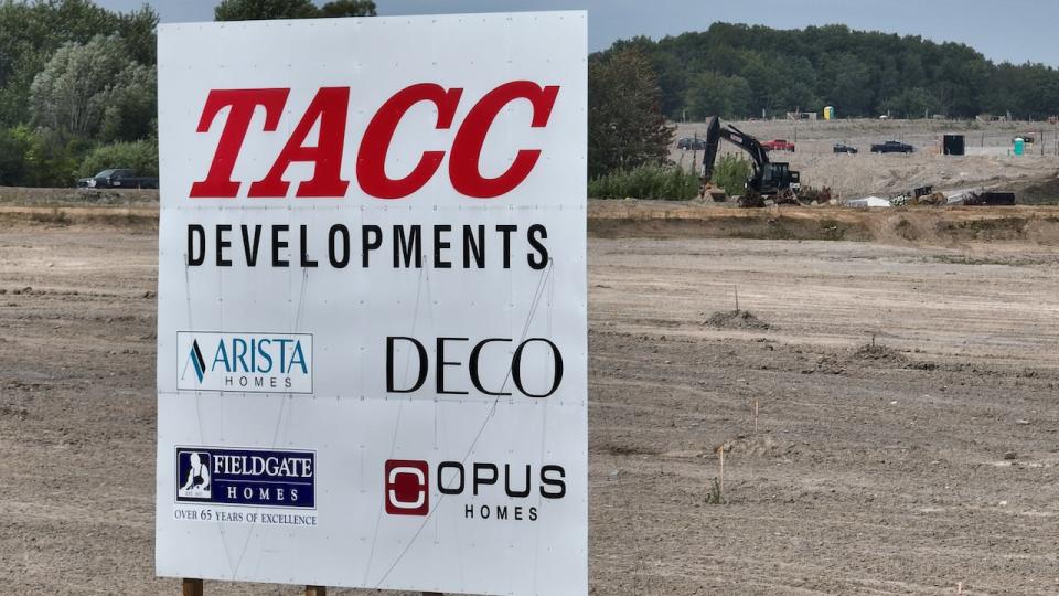 The logo of Tacc Developments and other companies is seen on a sign at an existing residential development located east of the Duffins Rouge Agricultural Preserve in Pickering, Ont., adjacent to the land removed from the Greenbelt.