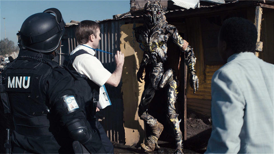 A social worker approaches an extraterrestrial refugee in “District 9”