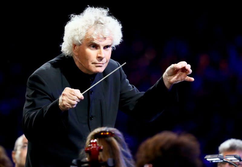 FILE PHOTO: Conductor Simon Rattle takes part in the opening ceremony of the London 2012 Olympic Games at the Olympic Stadium