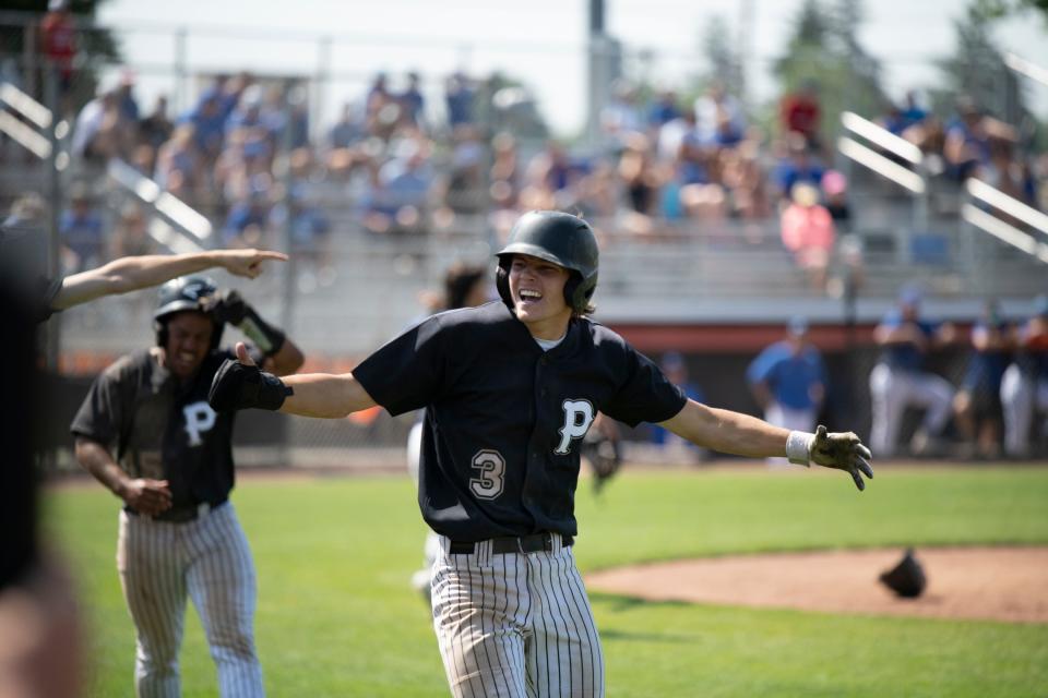 Cooper Hums (3) celebrates his second run of the game at the Lake Central High School Indians vs. the Penn High School Kingsmen baseball game in La Porte, Indiana on Saturday, June 10, 2023.