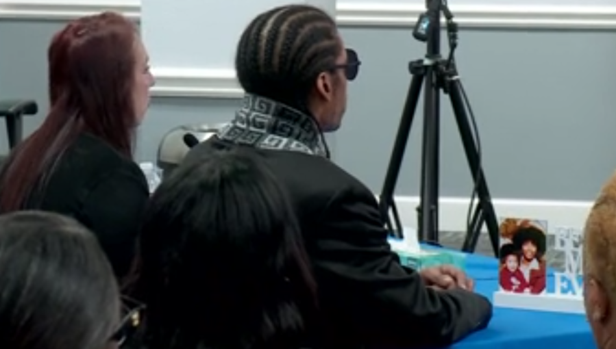 Janet Moore's son sits at Wednesday's clemency hearing with a picture of his mother in front of him. {KFOR}