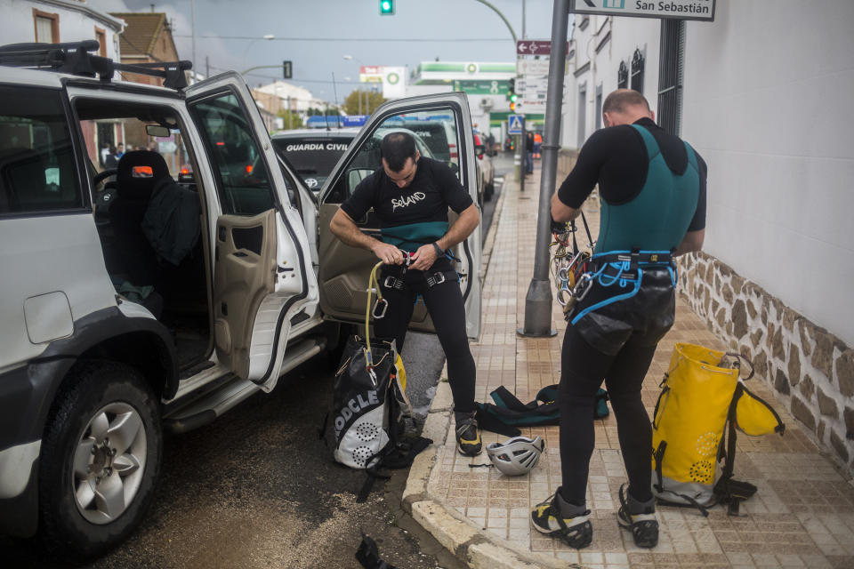 Members of the G.E.A.S. team of Spanish civil guard, set up in order to recover the body of a dead firefighter at the village of Campillos, Spain, where heavy rain and floods have caused severe damage and the death of a firefighter according to Spanish authorities Sunday, Oct. 21 2018. Emergency services for the southern region of Andalusia say that the firefighter went missing when his truck overturned on a flooded road during heavy rains that fell through the night, and his body was found after a search Sunday morning.(AP Photo/Javier Fergo)