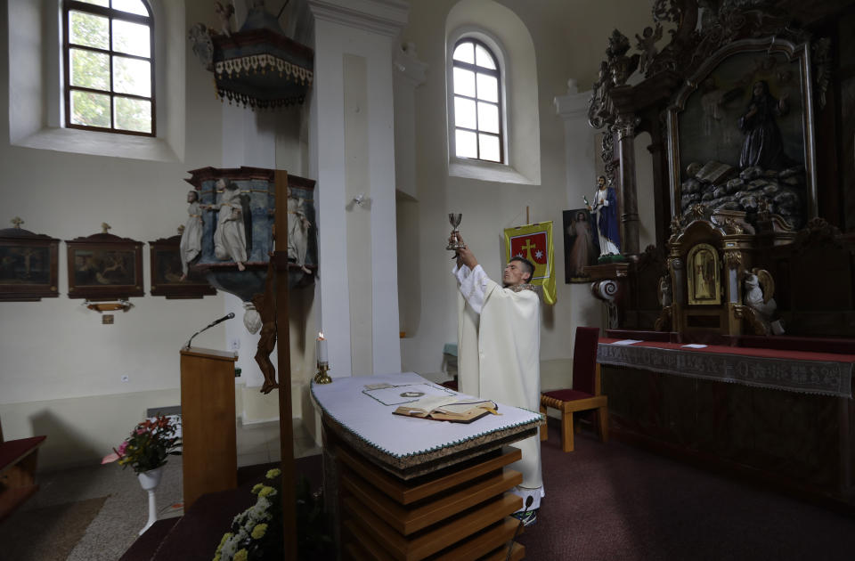 Roman Catholic priest Michal Lajcha serves a mass in a church in Klak, Slovakia, Monday, Sept. 17, 2018. Lajcha is challenging the Roman Catholic Church’s celibacy rules in a rare instance of dissent in the conservative religious stronghold in central and eastern Europe. (AP Photo/Petr David Josek)