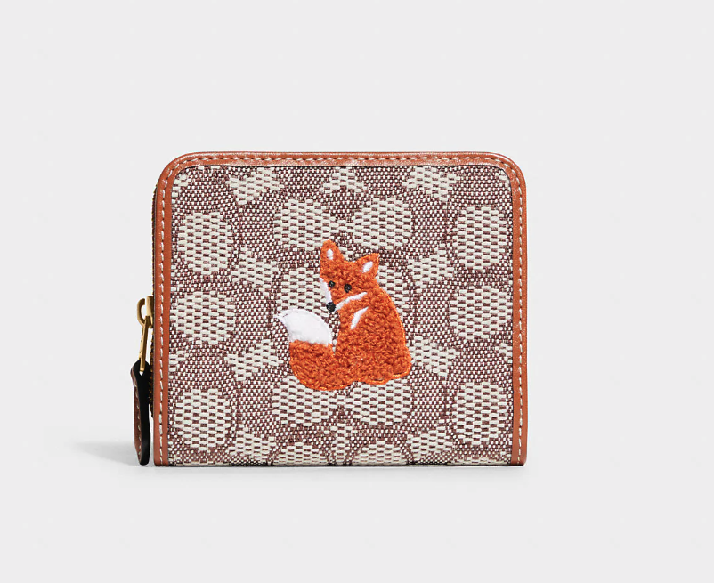 Billfold Wallet In Signature Textile Jacquard With Fox Motif. Image via Coach Outlet.