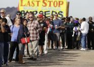 A crowd, consisting of residents from California and Nevada, lines up outside the Arizona Last Stop convenience store and souvenir shop to buy Powerball tickets, Tuesday, Nov. 27, 2012, in White Hills, Ariz. There has been no Powerball winner since Oct. 6, and the jackpot already has reached a record level for the game of over $500 million. (AP Photo/Julie Jacobson)