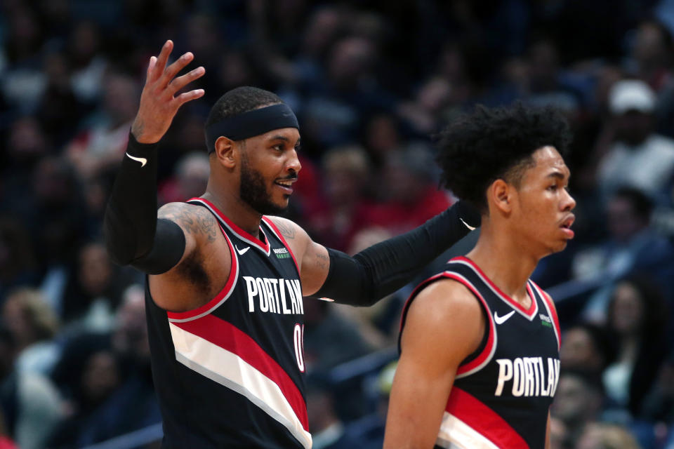 Portland Trail Blazers forward Carmelo Anthony, left, reacts as he walks to the bench with guard Anfernee Simons during the second half of the team's NBA basketball game against the New Orleans Pelicans in New Orleans, Tuesday, Nov. 19, 2019. The Pelicans won 115-104. (AP Photo/Gerald Herbert)