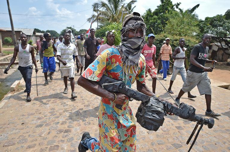 Protesters opposed to Burundi's President Pierre Nkurunziza, some of them armed, demonstrate in the Buyenzi neighborhood of Bujumbura on May 26, 2015