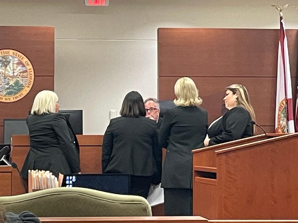 Lawyers from the defense and prosecution meeting with the judge