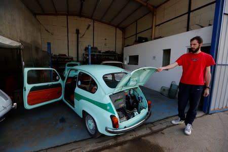 A worker opens the hatch of converted supermini car Zastava 750, which has its combustion engine replaced with an electric one by BB Classic Cars, in Skopje