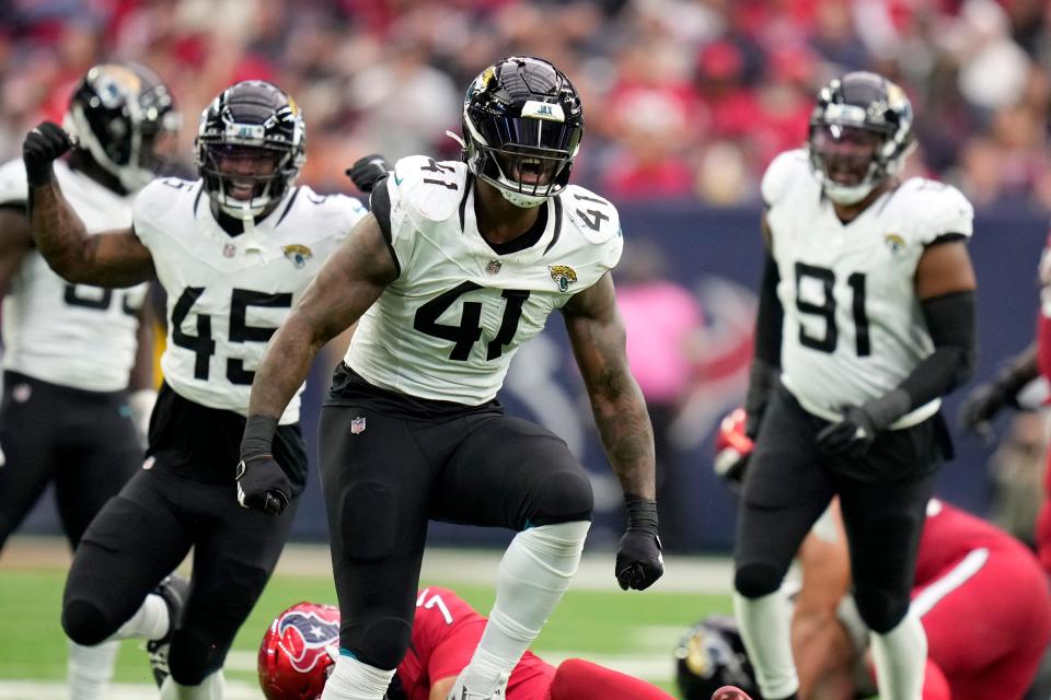 Jacksonville Jaguars linebacker Josh Allen (41), K'Lavon Chaisson (45) and Dawuane Smoot (91) celebrate after Allen sacked Houston Texans quarterback C.J. Stroud (7) in the second half of an NFL football game in Houston, Sunday, Nov. 26, 2023. (AP Photo/Eric Christian Smith)