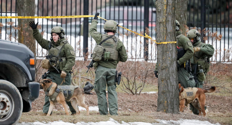 Pictured are authorities in camouflage at the scene of the Milwaukee shooting. 