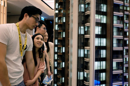People look at a model of LP6 property development by Nan Fung Group at a sales centre in Hong Kong, China August 26, 2018. Picture taken August 26, 2018. REUTERS/Bobby Yip
