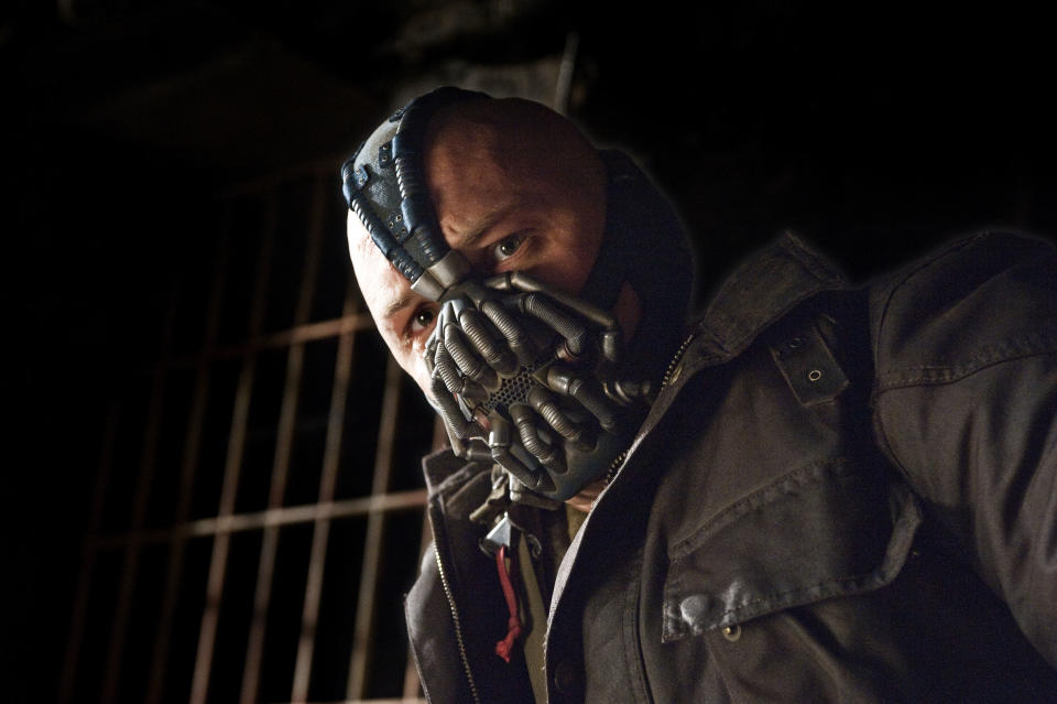 This undated film image released by Warner Bros. Pictures shows Tom Hardy as Bane in a scene from the action thriller "The Dark Knight Rises." A gunman in a gas mask barged into a crowded Denver-area theater during a midnight premiere of the Batman movie on Friday, July 20, 2012, hurled a gas canister and then opened fire, killing 12 people and injuring at least 50 others in one of the deadliest mass shootings in recent U.S. history. (AP Photo/Warner Bros. Pictures, Ron Phillips)