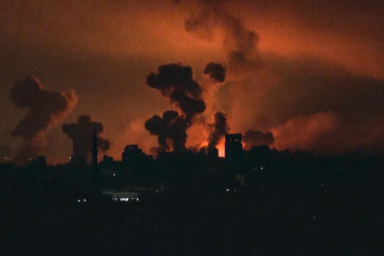 TV footage shows fire and smoke rising above Gaza City during an Israeli strike (AFP via Getty Images)