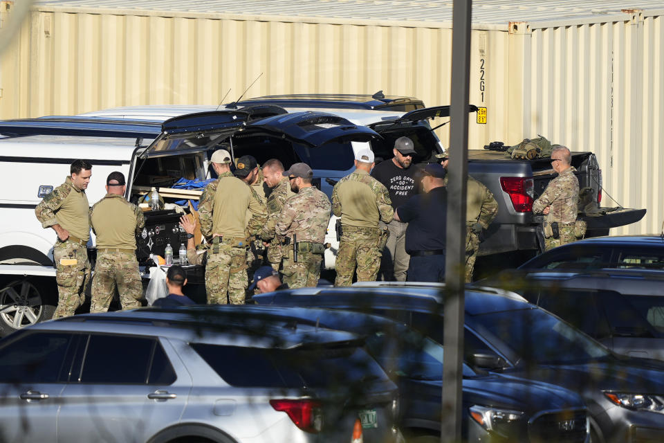 Law enforcement officers are staged in a school parking lot as a manhunt continues in the aftermath of a mass shooting in Lewiston, Maine, Friday, Oct. 27, 2023. Shocked and fearful Maine residents are keeping to their homes for a second night as hundreds of police and FBI agents search intently for Robert Card, a U.S. Army reservist authorities say fatally shot several people at a bowling alley and a bar. (AP Photo/Matt Rourke)