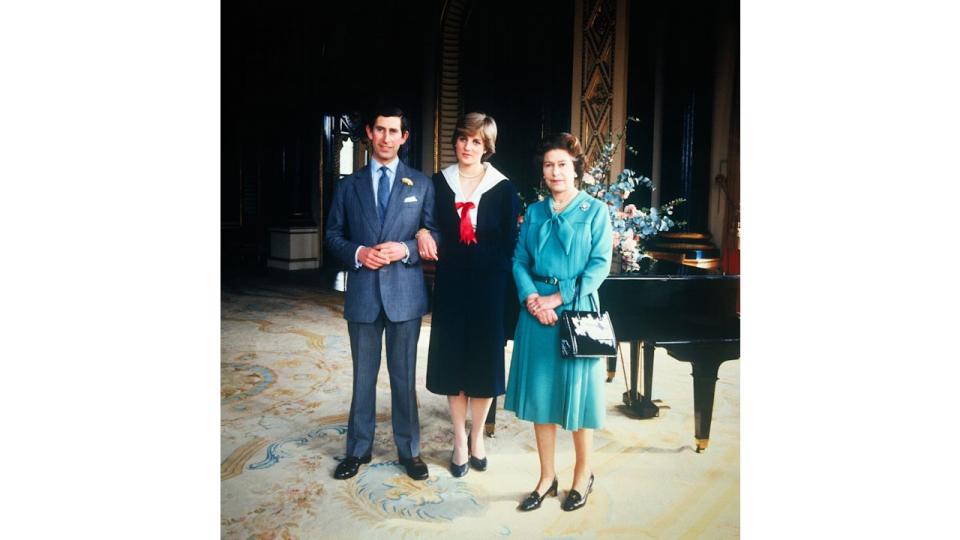  Diana wearing a nautical dress alongside the then Prince Charles and Queen Elizabeth in 1981