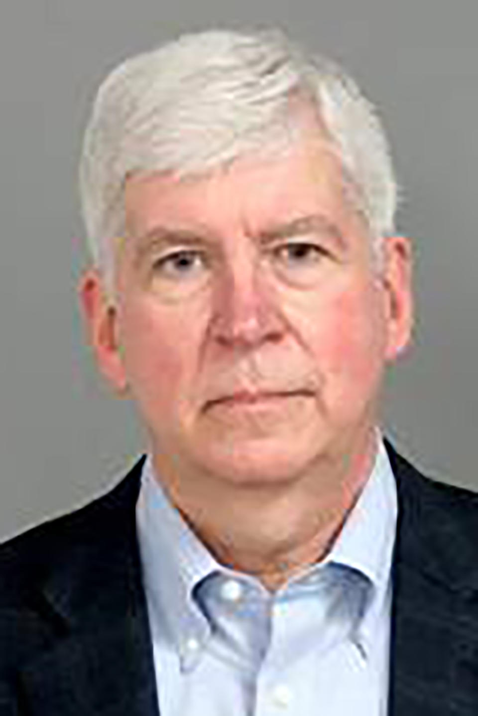 This Jan. 14, 2021 photo provided by the Genesee County Sheriff's Office in Flint, Mich., shows former Michigan Gov. Rick Snyder. Snyder was charged with two misdemeanor counts willful neglect of duty Jan. 14, 2021 in connection with the Flint water crisis in Flint, Mich. (Genesee County Sheriff's Office via AP)