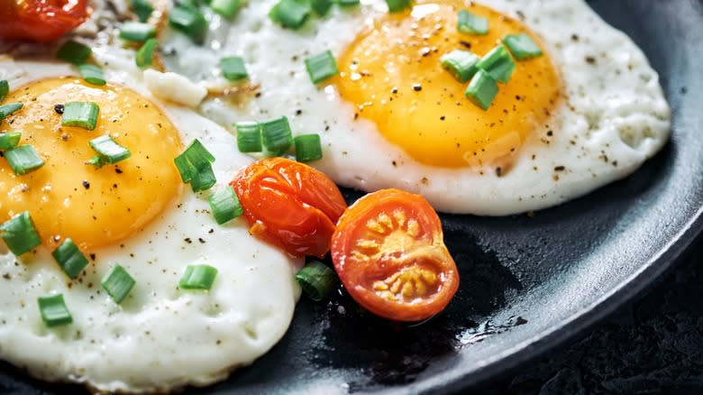 fried eggs with tomatoes