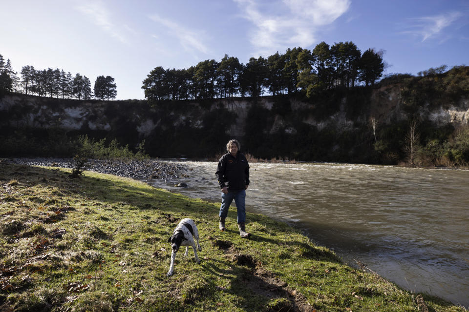 Glenn Martin, owner of the Blazing Paddles canoe rental business, walks along the Whanganui River in Piriaka, New Zealand, on June 16, 2022. “When you’re down here on the river, it just takes you to another place,” he says. “It’s relaxing. It’s soothing. It’s reinvigorating.” (AP Photo/Brett Phibbs)