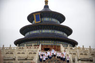 Students pose for a group photo at the Temple of Heaven in Beijing, Saturday, July 18, 2020. Authorities in a city in far western China have reduced subways, buses and taxis and closed off some residential communities amid a new coronavirus outbreak, according to Chinese media reports. They also placed restrictions on people leaving the city, including a suspension of subway service to the airport. (AP Photo/Mark Schiefelbein)