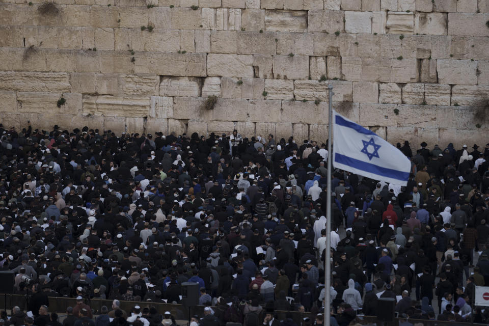 People attend a mass public prayer calling for the hostages held in the Gaza Strip to be released in front of the Western Wall, the holiest site where Jews can pray, in Jerusalem's Old City, Israel, Wednesday, Jan. 10, 2024. In its Oct. 7 attack, Hamas and other militants took captive roughly 250 people, including men, women, children and older people. Around 110 people have been released and some 110 remain, along with about 20 people who were killed while in captivity, Israeli authorities say. (AP Photo/Leo Correa)