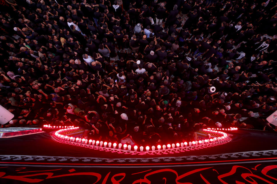 Iraqi Shiites take part in Ashura that marks the martyrdom of Husayn ibn Ali, a grandson of the Islamic prophet Muhammad, and members of his immediate family in the Battle of Karbala, in Karbala, Iraq, Monday, Aug. 8, 2022. (AP Photo/Anmar Khalil)