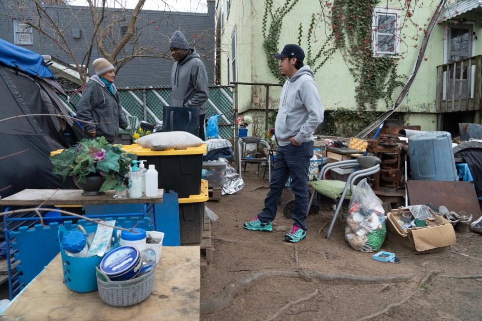 Center, Dan Harp and Adrian Bautista, of Collaborative Support Programs of New Jersey, meet with Donna, a woman who has been living in a tent for years in Bergen County on Wednesday March 27, 2024.