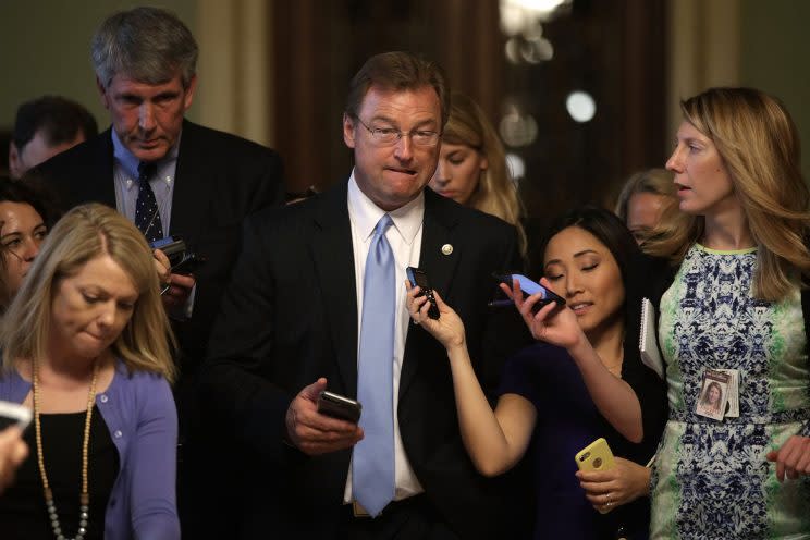 Sen. Dean Heller (R-NV) (C) is surround by members of the media as he is on his way to view the details of a new health care bill July 13, 2017 at the Capitol in Washington, DC. (Photo: Alex Wong/Getty Images)