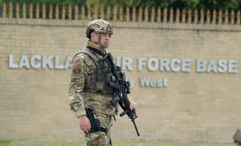 A military policeman stands guard at JBSA-Lackland Air Force Base game, Wednesday, June 9, 2021, in San Antonio. The Air Force was put on lockdown as police and military officials say they searched for two people suspected of shooting into the base from outside. (AP Photo/Eric Gay)