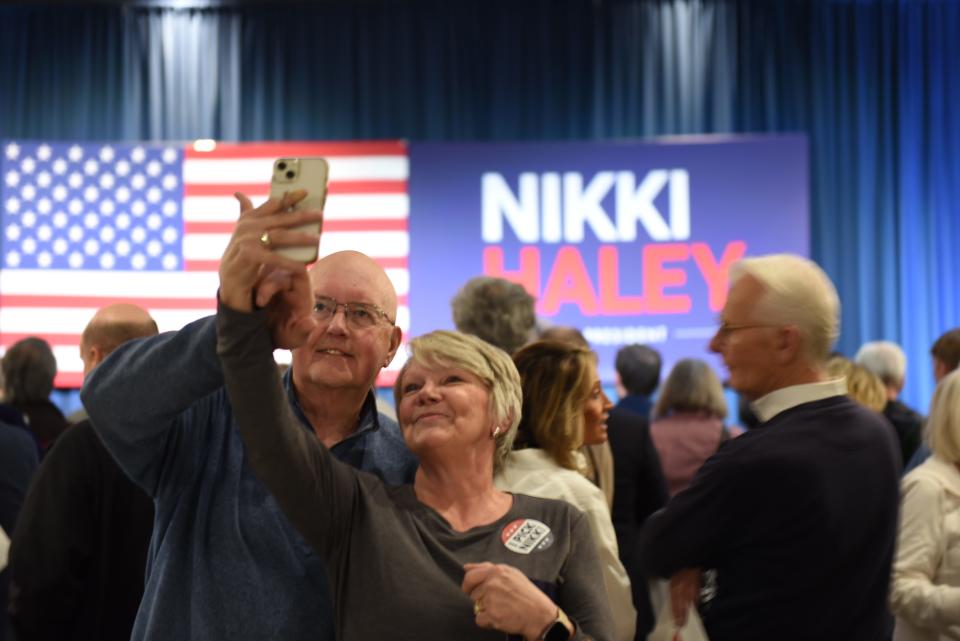 Nikki Haley supporters take photos in front of her campaign sign in Bloomington, Minn. on Feb. 26, 2024. ahead of the Super Tuesday presidential nominating contest.