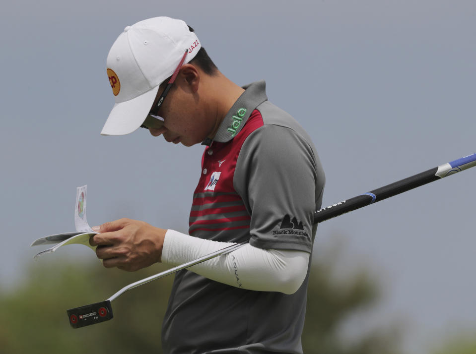 Jazz Janewattananond, of Thailand, checks his notes before putting on the 12th green during the second round of the PGA Championship golf tournament, Friday, May 17, 2019, at Bethpage Black in Farmingdale, N.Y. (AP Photo/Charles Krupa)
