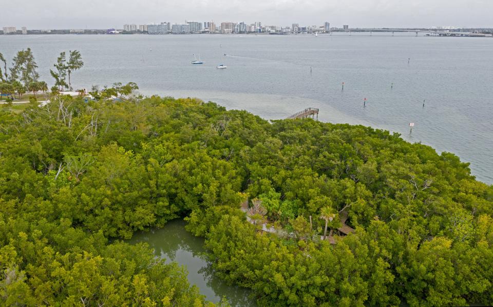 Ken Thompson Park overlooking Sarasota with a fishing pier, walking paths, canoe and kayak launches with a boat ramp, picnic areas, drinking fountains, playground, leashed pets permitted, electric vehicle charger, and restrooms that are open daily from 7:00 a.m. to 8:00 p.m.