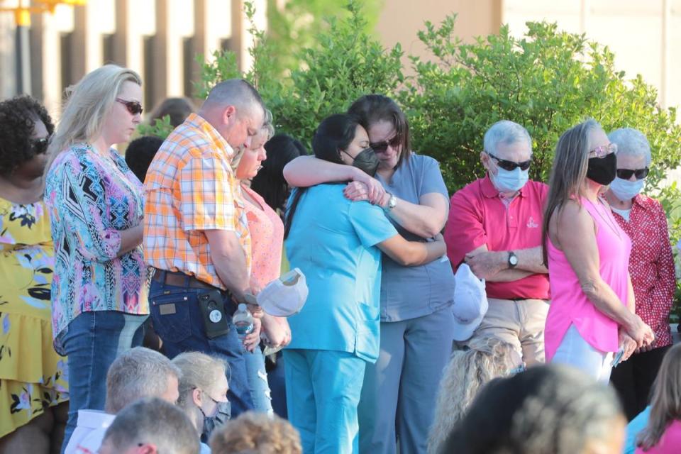 Mourners hug and pray Sunday at a vigil in memory of Robert, Barbara, Adah and Noah Lesslie of Rock Hill and James Lewis and Robert Shook, both of Gastonia, NC.