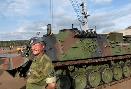 Colonel Eystein Kvarving, chief spokesman at the Norwegian Armed Forces Headquarters media centre stands near a German military armoured vehicle after it was unloaded at Fredrikstad, Norway, September 7, 2018. REUTERS/Gwladys Fouche