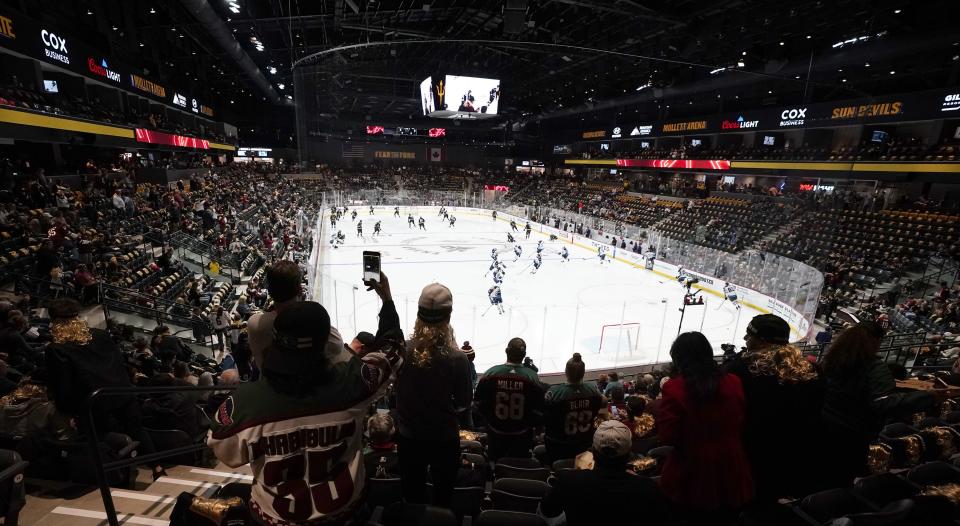 Fans watch as players warm up prior to the Arizona Coyotes’ home-opening NHL hockey game against the Winnipeg Jets at the 5,000-seat Mullett Arena in Tempe, Ariz., Oct. 28, 2022. | Ross D. Franklin, Associated Press