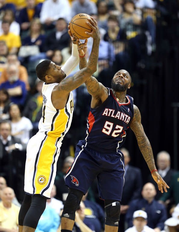 Paul George (L) of the Indiana Pacers and DeShawn Stevenson of the Atlanta Hawks reach for a loose ball on April 21, 2013. George posted 23 points, 12 assists and 11 rebounds to lead Pacers to their first game-one win in a playoff series since 2006