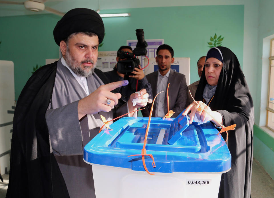 Shiite cleric Muqtada al-Sadr casts his vote at a polling station in the Shiite holy city of Najaf, 100 miles (160 kilometers) south of Baghdad, Iraq, Wednesday, April 30, 2014. Iraq is holding its third parliamentary elections since the U.S.-led invasion that toppled dictator Saddam Hussein. More than 22 million voters are eligible to cast their ballots to choose 328 lawmakers out of more than 9,000 candidates. (AP Photo/Jaber al-Helo)