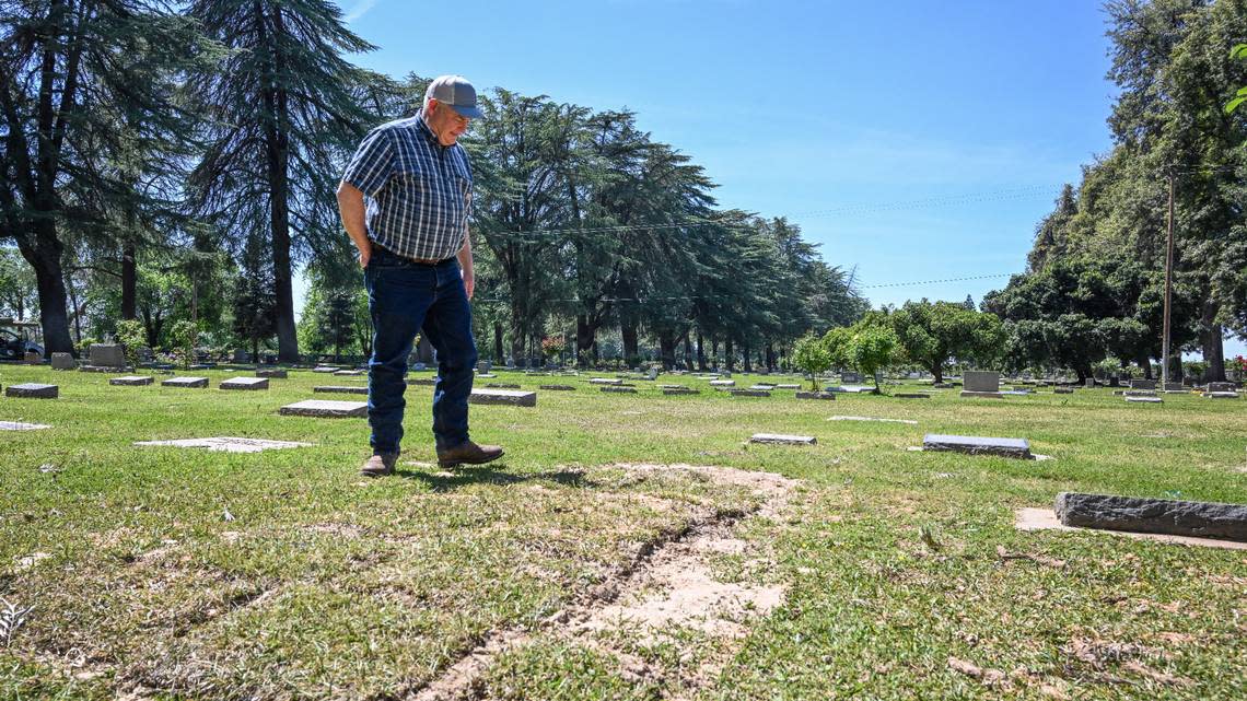 Barry Cummings of Molt, Montana looks over the former grave of his uncle Eric Cummings at the Sanger Cemetery after having the remains exhumed more than 80 years after Eric Cummings’ death, on Wednesday, April 10, 2024. Barry Cummings is transporting the body back to a family cemetery in Everton, Missouri.