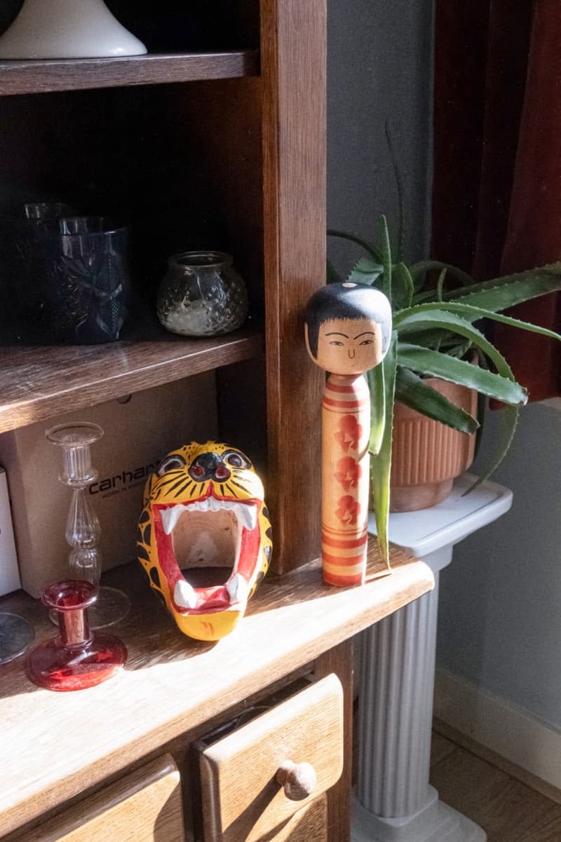 A wooden shelf with decorative items.